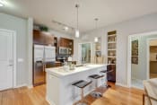 Thumbnail 1 of 16 - Kitchen with island, white quartz counters and dark cabinets