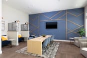 Thumbnail 8 of 22 - a conference room with a blue accent wall and a wooden table