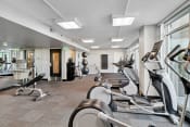 Thumbnail 29 of 50 - a gym with various exercise machines and windows