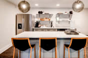Thumbnail 1 of 29 - a kitchen with a large center island with a white countertop at Hamilton at Kings Place, Maryland, 21046