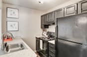 Thumbnail 6 of 29 - a kitchen with black appliances and white countertops at Hamilton at Kings Place, Columbia, 21046