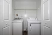 Thumbnail 17 of 22 - a washer and dryer in a laundry room