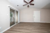 Thumbnail 15 of 22 - a bedroom with hardwood floors and a ceiling fan
