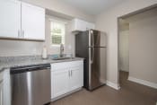 Thumbnail 4 of 22 - newly renovated kitchen with white cabinets, stainless steel appliances, and granite countertops