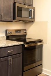 Thumbnail 3 of 66 - Kitchen with a stove and microwave in a 555 waverly unit at Ivy Hall Apartments*, Towson Maryland
