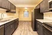 Thumbnail 1 of 66 - Kitchen with dark cabinets and white countertops at Ivy Hall Apartments*, Maryland