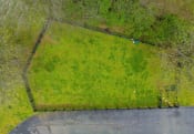 Thumbnail 19 of 27 - an aerial view of a grassy area with a fence around it