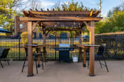 Thumbnail 5 of 16 - a pergola with two tables and a grill
