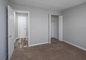 Thumbnail 14 of 27 - a bedroom with gray walls and a carpeted floor