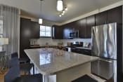 Thumbnail 9 of 28 - a kitchen with stainless steel appliances and a granite counter top