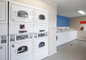 Thumbnail 22 of 27 - a washer and dryer in a laundry room