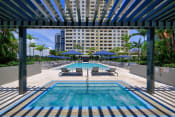 Thumbnail 4 of 14 - a swimming pool with lounge chairs and umbrellas in front of a building at Regatta at New River, Fort Lauderdale, 33301
