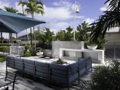 Thumbnail 6 of 12 - a patio with a fire pit and seating at Saba Pompano Beach, Pompano Beach, FL