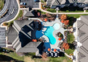 Thumbnail 28 of 31 - an aerial view of a swimming pool in a neighborhood with houses