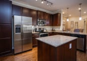 Thumbnail 12 of 31 - a kitchen with stainless steel appliances and granite counter tops