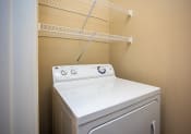 Thumbnail 18 of 31 - a washer and dryer in a laundry room with a rack on the wall