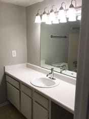 Thumbnail 5 of 8 - Bathroom sink and mirror at Landmark Apartment Homes, Meridian, Mississippi