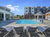 Thumbnail 16 of 78 - Pointe at Prosperity Village Swimming Pool With Lounge Chairs in Charlotte, NC Apartment Rentals for Rent