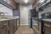 Thumbnail 13 of 48 - Galley Kitchen with Stainless appliances at Monterra Ridge Apartments, Canyon Country, CA