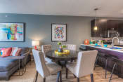 Thumbnail 70 of 78 - a dining area with a table and chairs and a kitchen in the background  at EdgeWater at City Center, Lenexa, 66219