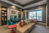 Thumbnail 43 of 78 - a living room filled with furniture and a large window  at EdgeWater at City Center, Lenexa, 66219