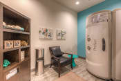 Thumbnail 50 of 78 - a room with a chair and tanning bed  at EdgeWater at City Center, Lenexa, KS, 66219