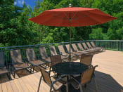 Thumbnail 6 of 22 - Sundeck with Umbrellas and Dining Tables at Parkridge Apartments, Oregon
