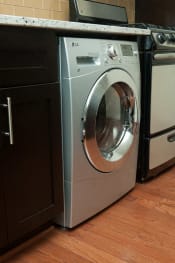 Thumbnail 23 of 25 - a front loading washer and dryer sit next to each other in a kitchen