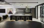 Thumbnail 5 of 29 - a large black kitchen with a table and chairs