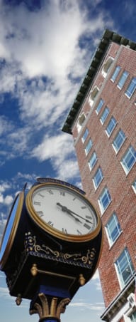 a clock in front of a brick building