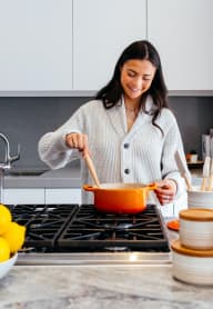 A woman is cooking in a kitchen with a bowl of lemons on the counter. at Brookstone, Washington, 98198