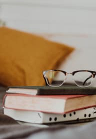 a pair of glasses sitting on top of a pile of books at Baldwyn, Washington