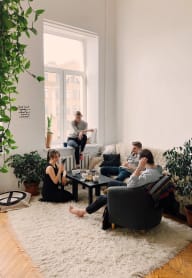 a group of people sitting in a living room at Cosmopolitan, Seattle, Washington