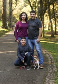 A family of three with a dog on a walk in a park. at The Retreat, Sumner, WA, 98390