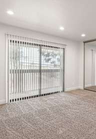 A white closet with a bench and a hanger.