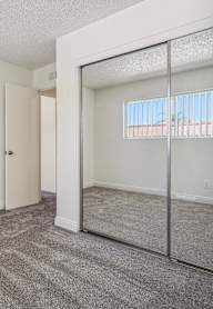 A white closet with a bench and a hanger.