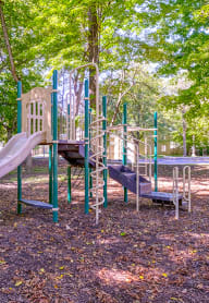 a playground with a slide and slides in a park