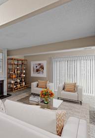 a living room with white furniture and a fireplace