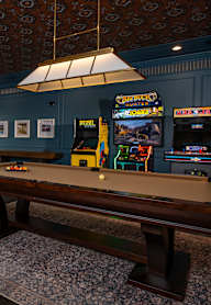 A room with a pinball machine and a basketball game. at Maison Apartments, Apartments, Westerville, OH