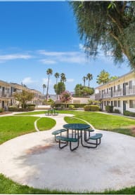 a park with a picnic table and a tree in a courtyard at Sunnymead Apts Apartments, Moreno Valley, California