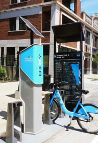 a blue bike parked next to a phone booth