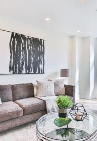 a living room with a couch and a glass coffee table