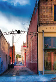 a street scene with a blue building and a red building