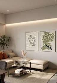 A living room with a sofa, a coffee table, and a framed poster that says "There is no place like home.".