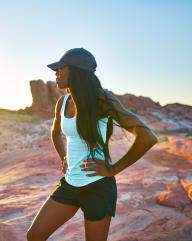 a woman running in the desert at sunset