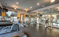 the gym has a wall of dumbbells and exercise equipment at The MK, Indiana