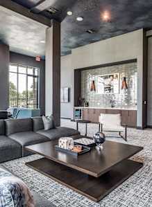 a living room with a gray couch and a coffee table