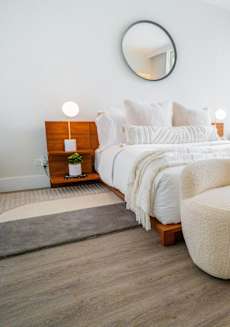 a bedroom with a large window and a bed with white blankets and pillows at 21 E Chestnut, Chicago, IL