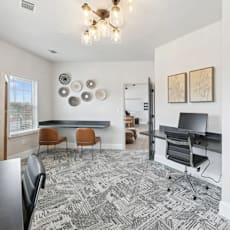 A room with a patterned carpet and a wooden floor.