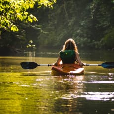 a woman in a kayak on a river
